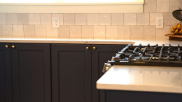 Custom navy and gold kitchen remodel in Grand Rapids, MI — flat-panel cabinetry, brass hardware, and quartz counters. Custom navy and gold kitchen remodel in Grand Rapids, MI — flat-panel cabinetry, brass hardware, and quartz counters.